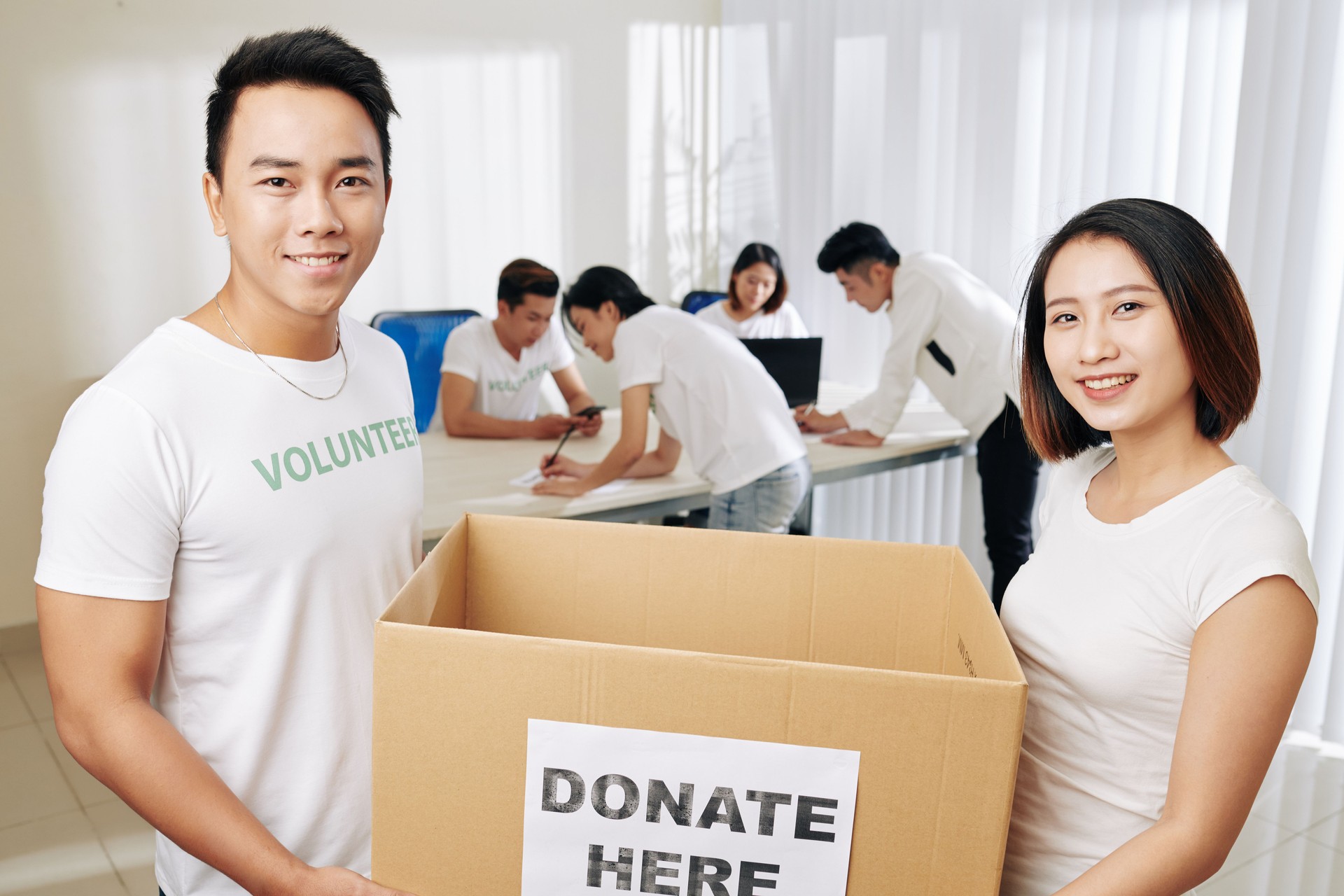 People carrying donation box