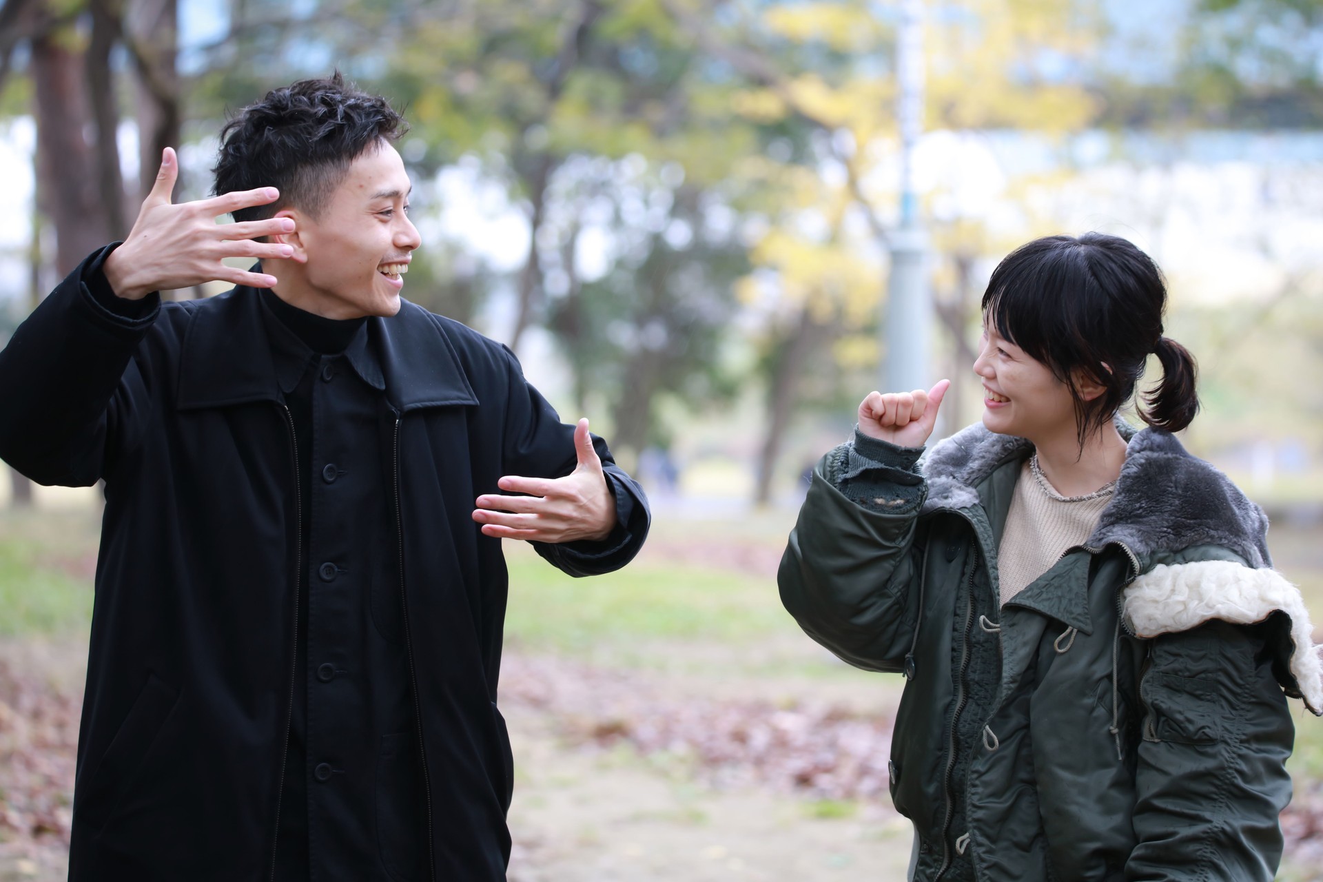 Image of a couple speaking sign language "movie" "like"